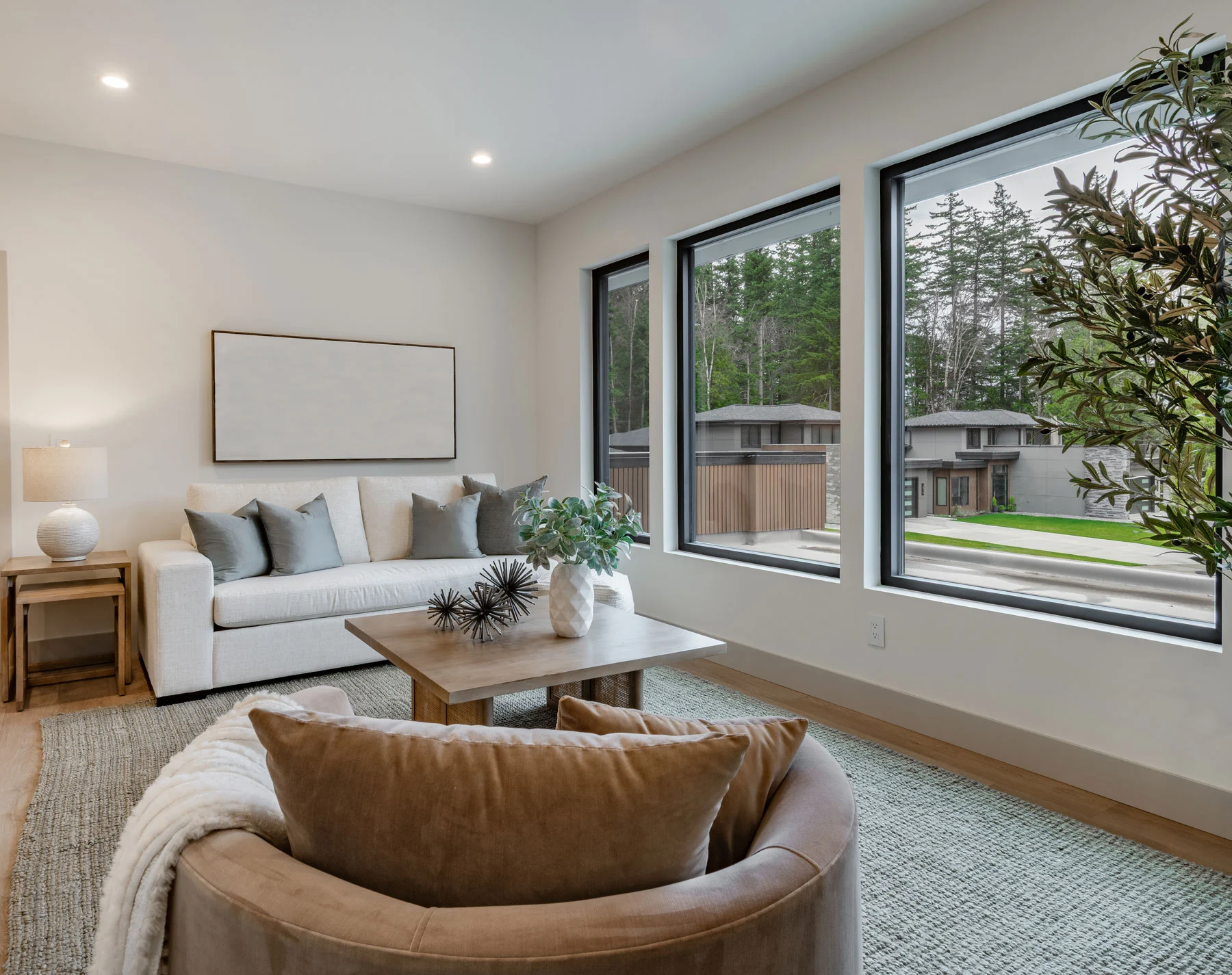 Gray sectional sofa decorated with contrasting white and silver plush pillows